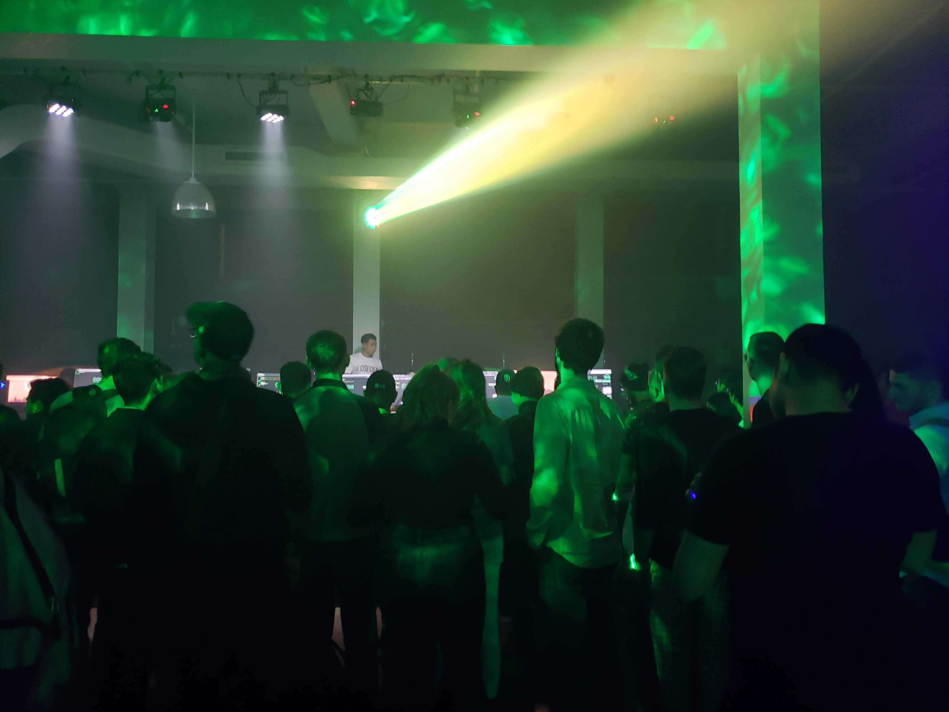 Crowd in a dark nightclub-like environment at Code in the Dark Montreal 2019.
